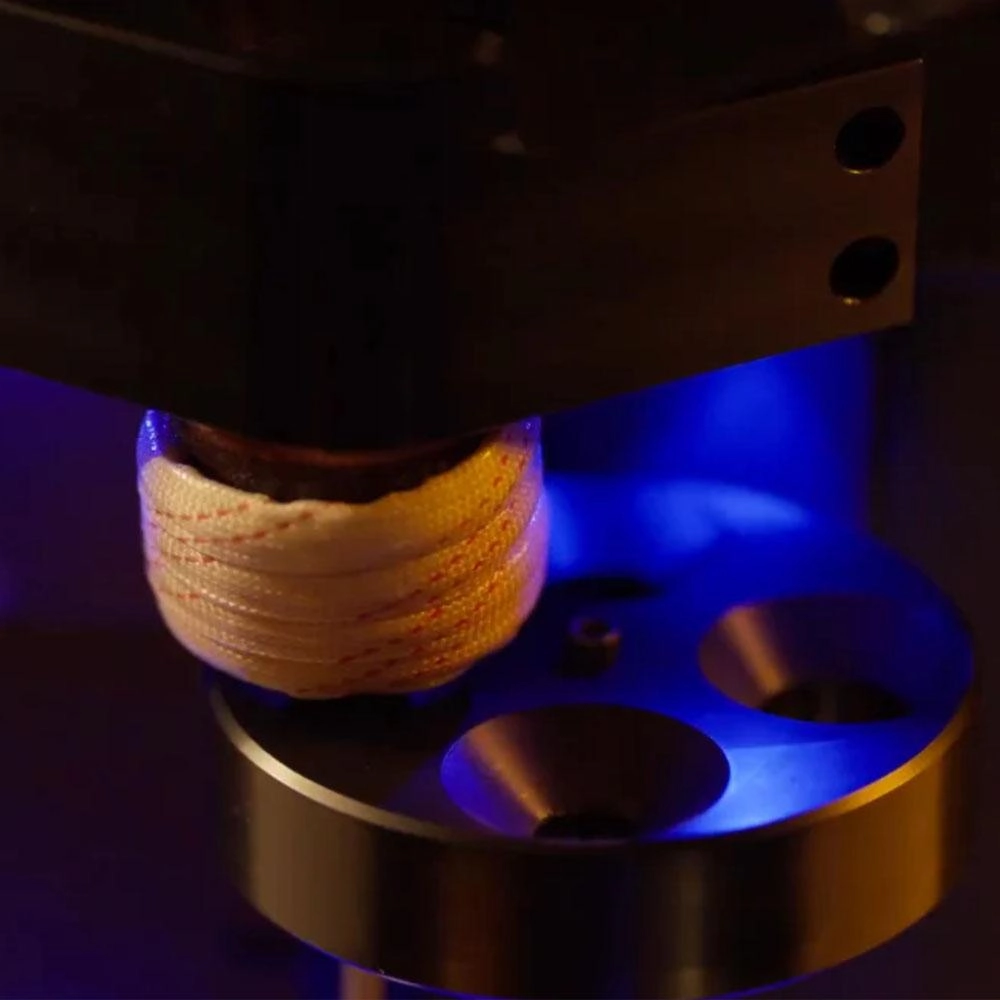 Induction coil of the BurstFire 2-in-1 annealer with a case being fed into it