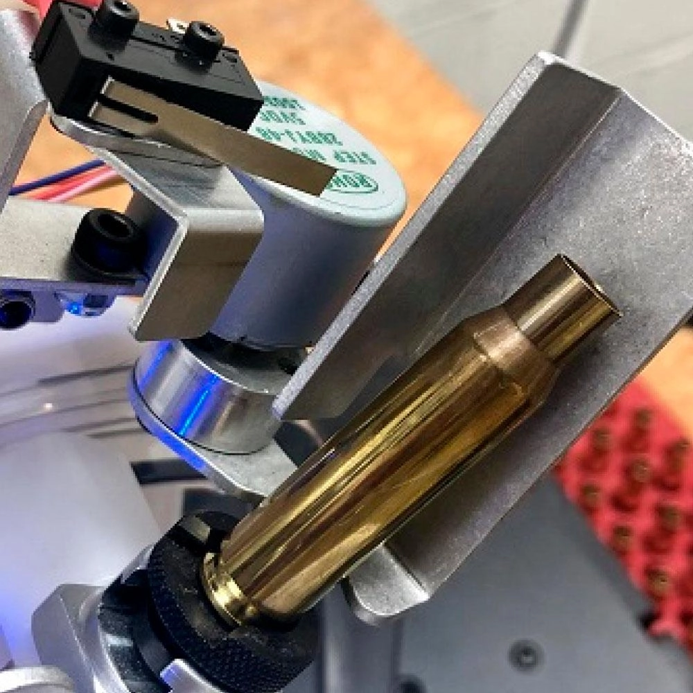 Close-up of the AMP MATE placing a brass case into the pilot