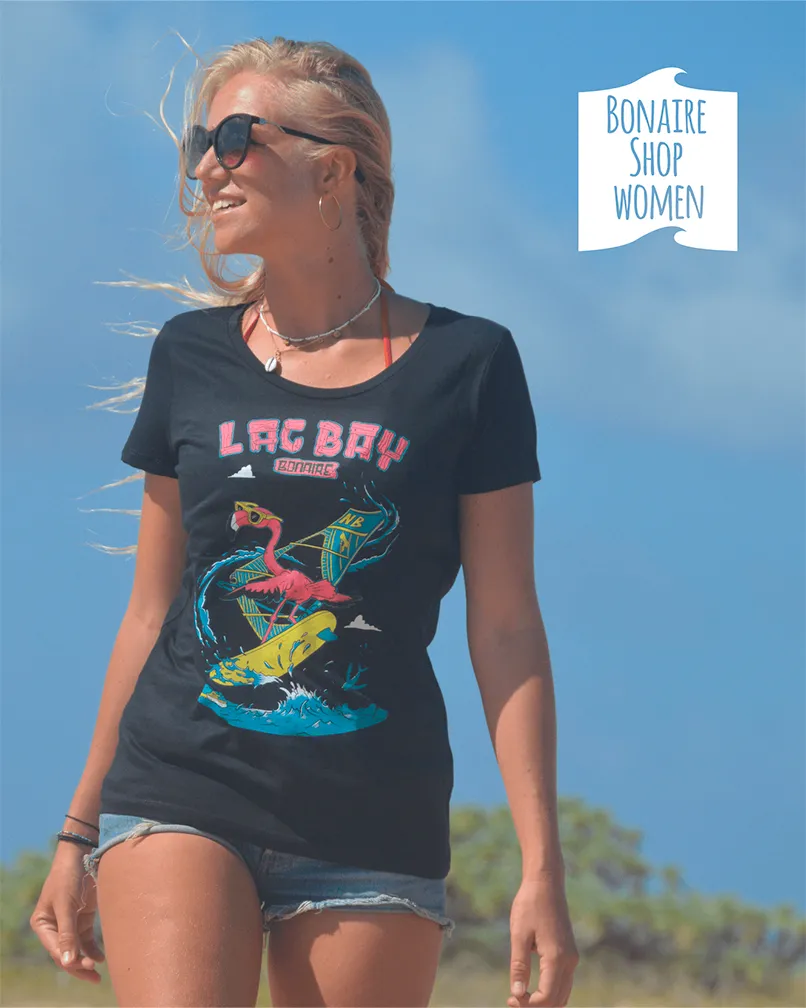 Young lady wears a black T-shirt with the design of a Flamingo doing windsurfing tricks at Lac Bay on Bonaire