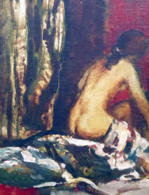 Rug van naakte vrouw op bed gezeten