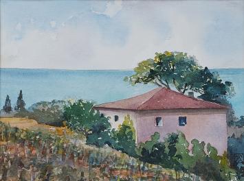 Zicht op een huisje aan zee in de Provence