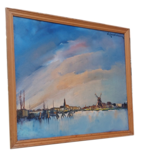 Dorpje met windmolen aan het water